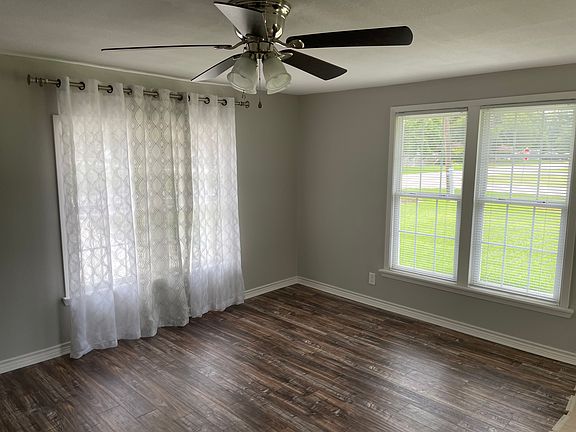Rustic wood flooring and stainless fans and nice windows