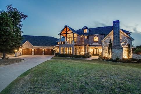 Gorgeous 3-story with rich architecture, long driveway leading to 3-car garage bays, beautiful professional landscaping and outdoor lighting, and covered balcony