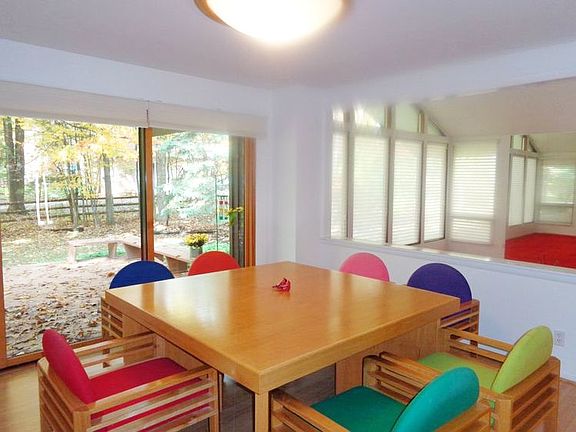 Dining room open to the living room with a sliding glass door to the deck.