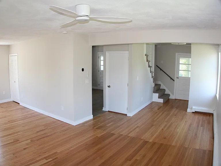 Living Room, Entrance to Kitchen and Basement. Staircase to 2nd Floor.