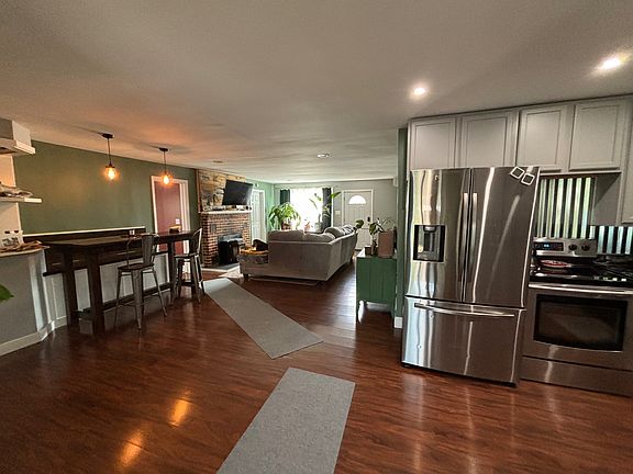 Dining/kitchen/living area. View from back of house facing front door