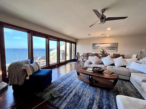 Large living and dining room looking out to the open waters through floor to ceiling windows