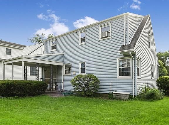 Another view of back of house with flat, level yard