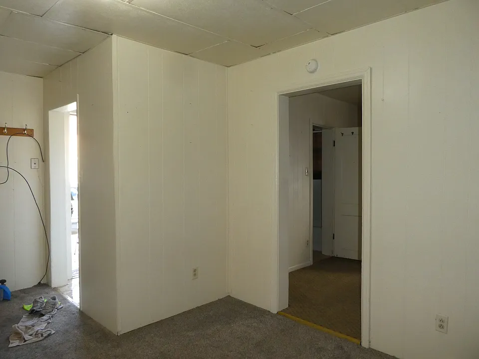 Living room with doors to kitchen and bedroom
