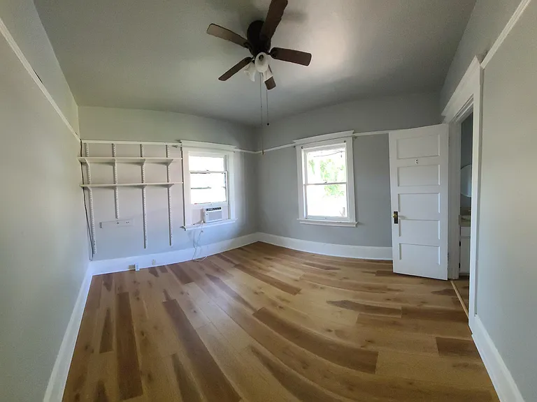Master bedroom with attached bathroom with shower.