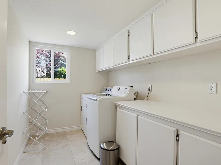Downstairs utility room with washer and dryer.