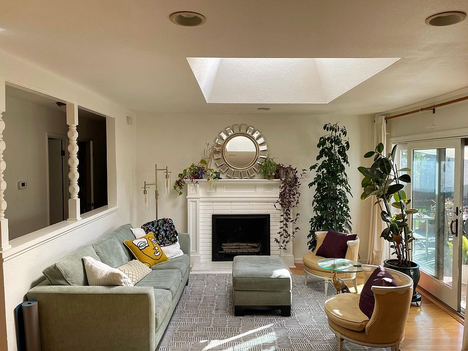 Living Room with Skylight + Patio Entrance to Backyard