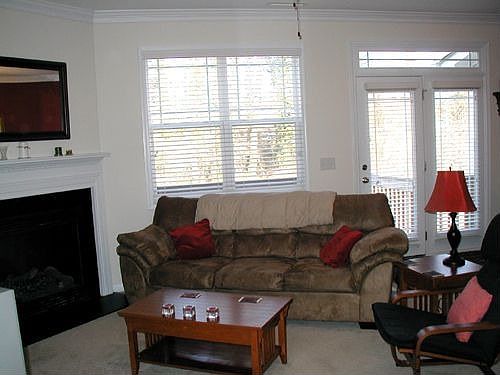 Family Room has plantation blinds and is open to dining and kitchen