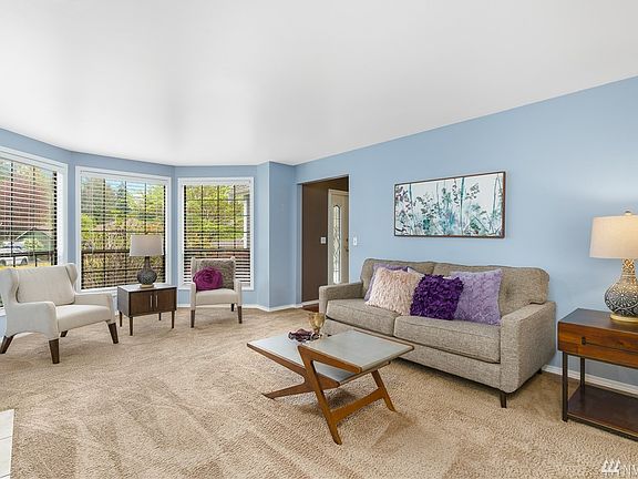 Living room bay window overlooking front yard landscape.