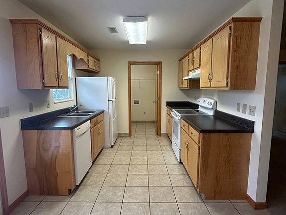 Galley kitchen and entrance to laundry room