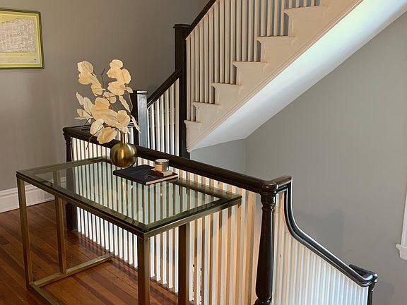 Staircase continues from the second floor (main living level) to the third floor (additional bedroom and full bath)