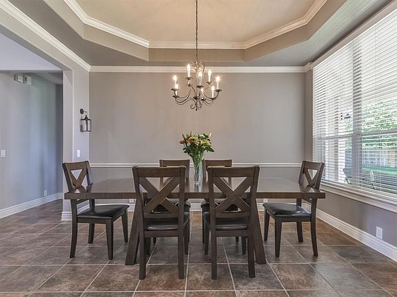 Formal Dining Room features tray ceiling, classic chair rail, and double crown molding.
