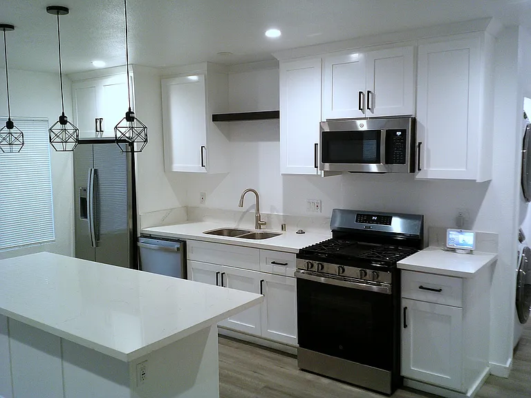 Open Kitchen Space with large island and counter (white marble)