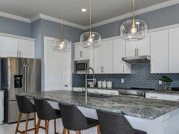 Open Kitchen with Island, Generous Counter Space and Stainless Steel Appliances
