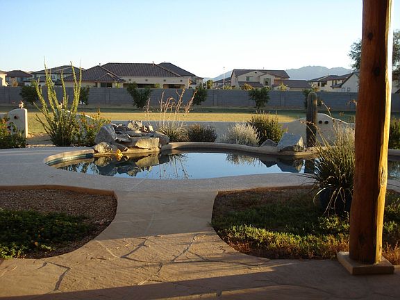 Boulder waterfall and huge 1.08 acre lot fully landscaped!