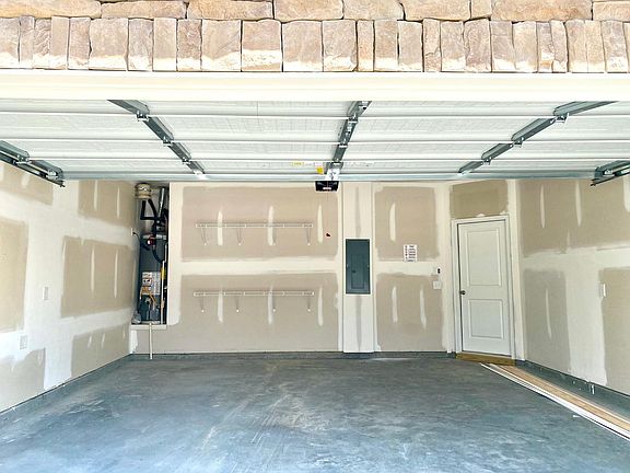 Double car Garage with Garage door opener and two 6' shelves. EV Charging port available on request.