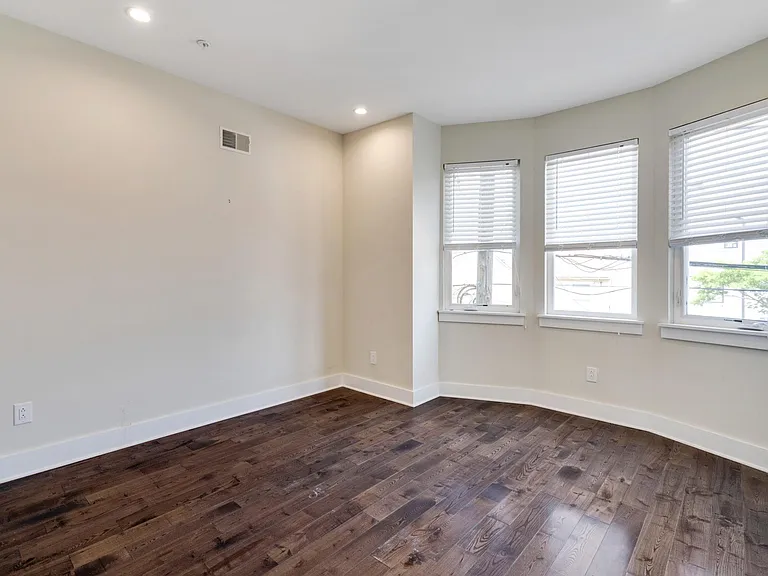 Bedroom with window-nook facing front of the home