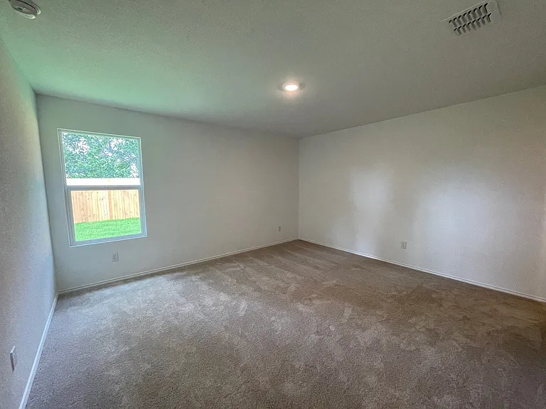 Primary bedroom overlooking the back yard.