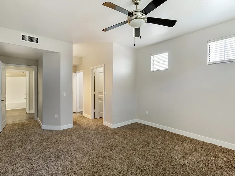 Relax in our carpeted bedroom, complete with a soothing ceiling fan