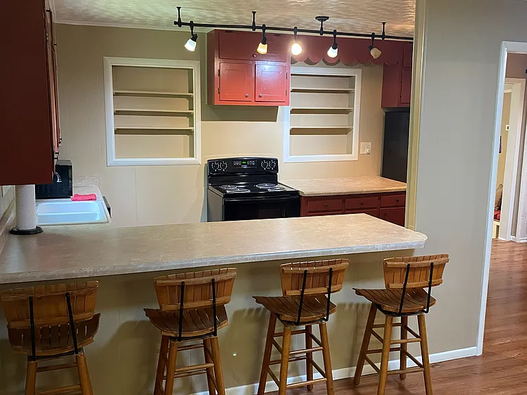 Kitchen area with eat in bar from living area POV.