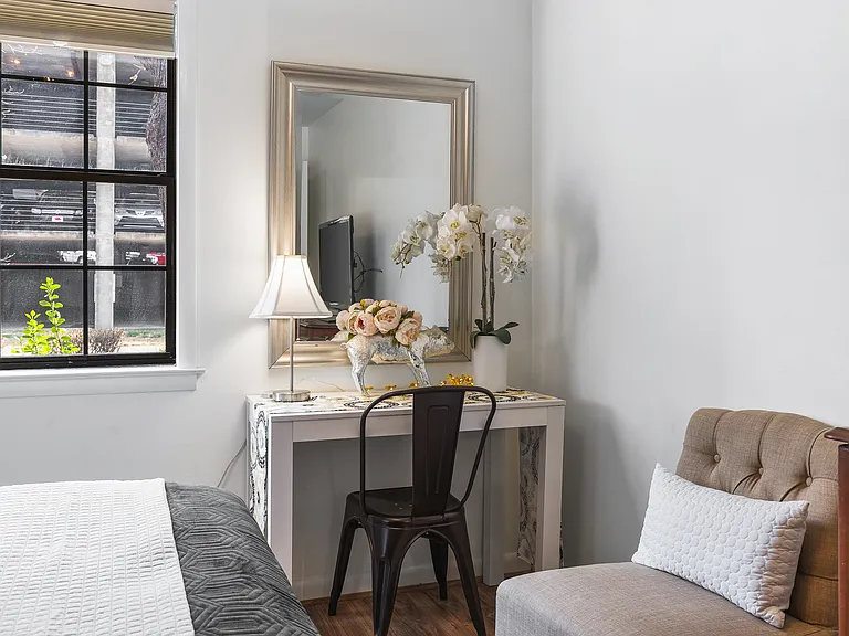 Comfortable King bed in the bedroom. Includes a smart TV, desk to get ready at, dresser and a closet to store your items in.