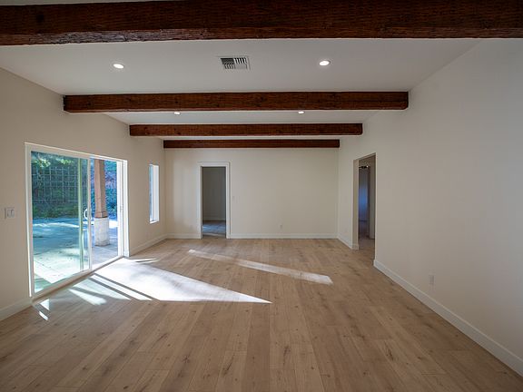 Exposed beams and new flooring add a lot of light and character to this room.