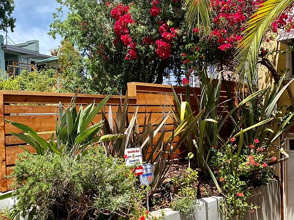 Driveway planter and new farm-house style fencing with new LED uplighting_