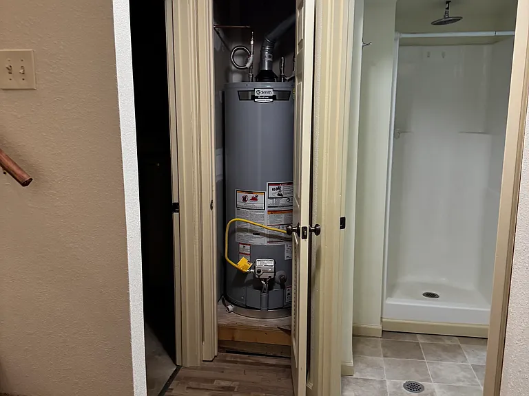 New water heater with utility room to the right and bathroom to the left.