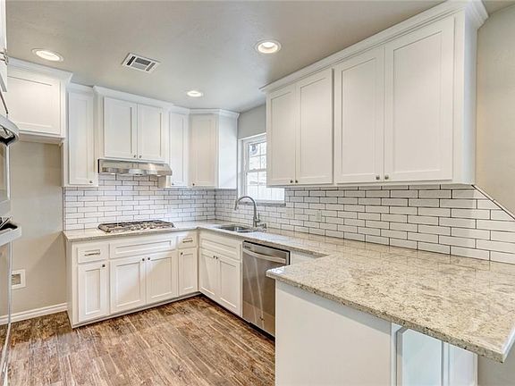 Custom cabinets with pull out drawers below range for pots/pans plus a place for baking sheets.