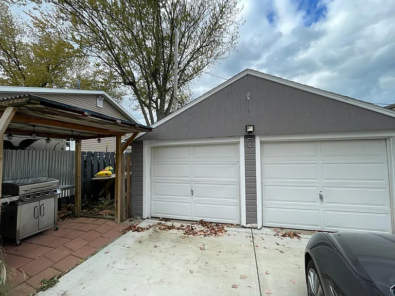 Two car garage w/covered trash/grill