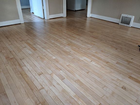 Refinished flooring in the Living Room. Looking into BR1 and Kitchen.