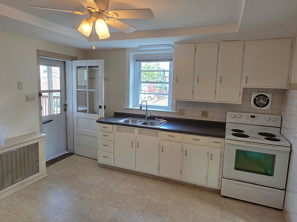 Eat-in kitchen with view and doorway to back deck.