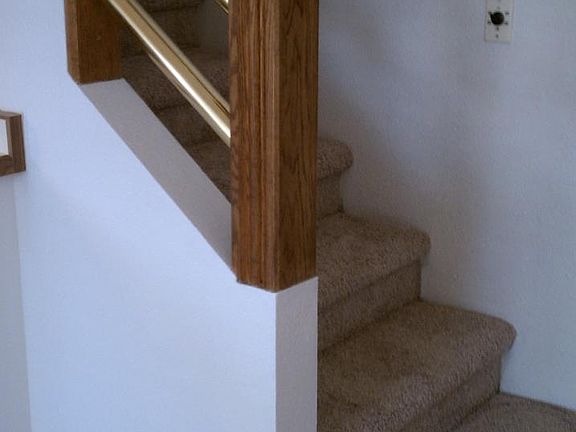 Brass railing by stairs