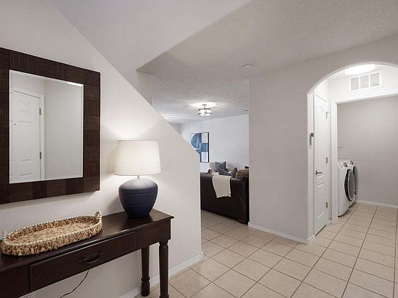 Entry, with view of living room and laundry