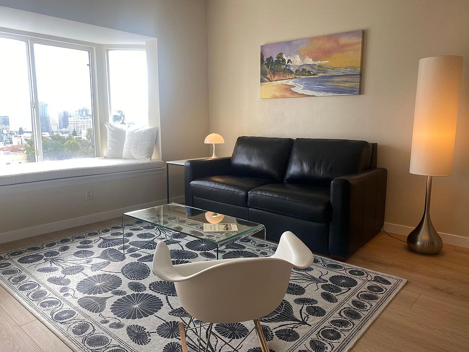 Living room with window seat overlooking the downtown skyline.