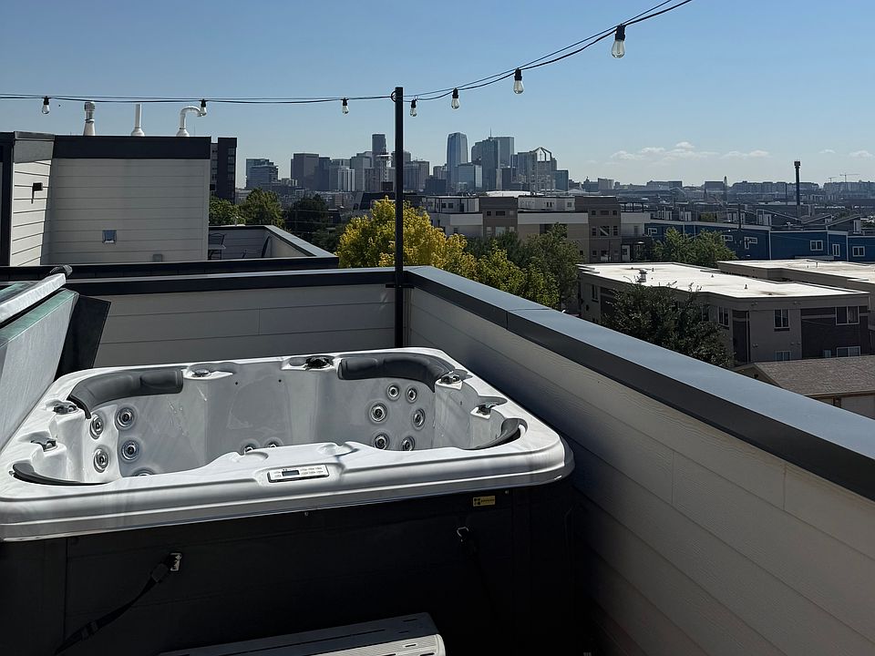 Private new hot tub on huge rooftop deck, overlooking the city.