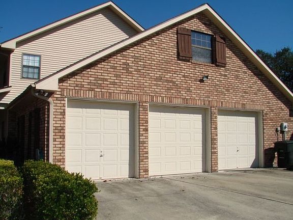 Large 3 car garage with bathroom serving pool area