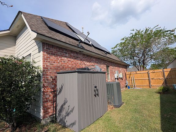 Side yard of house including solar panels and new air unit