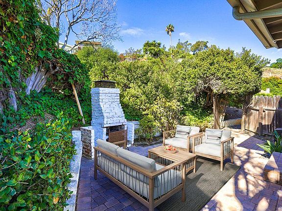 Private enclosed back yard with patio, pavers underfoot.