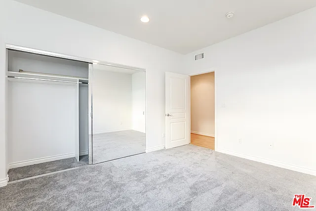 Second large bedroom with wall of mirrored closets