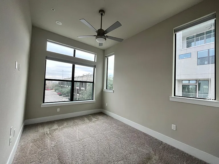 Primary bedroom with ceiling fan. Blackout blinds in room.