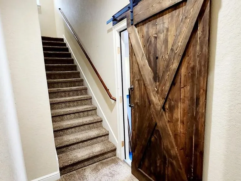 Fram door leading to the large two car garage with additional storage space