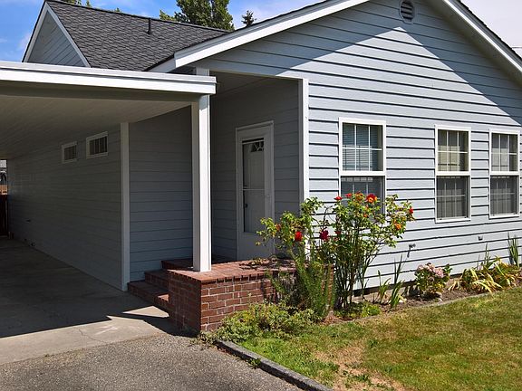 All landscaping has been cut back. Long carport with gate to backyard.