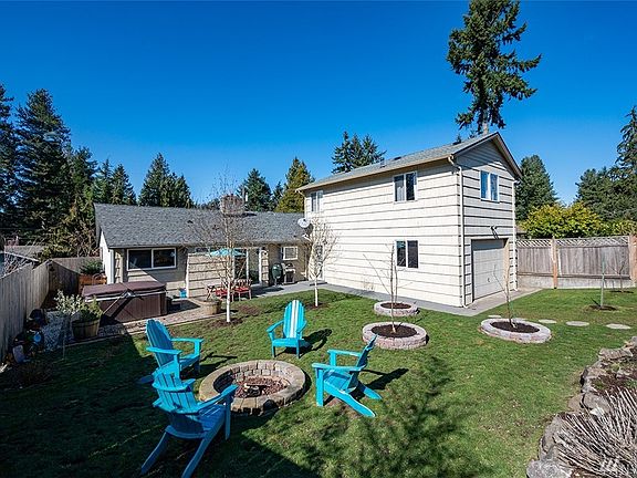 What a backyard wonderland! Entertain around the firepit, fire up the grill or soak in the hot tub. 
