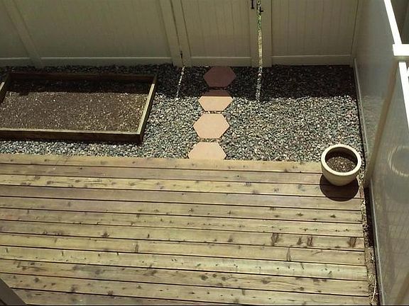 Small fenced backyard deck & raised bed 2nd floor view