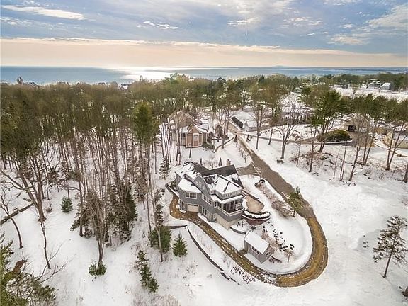 Aerial view of property with water beyond.