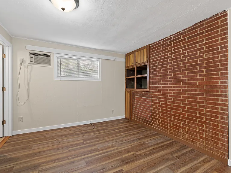 Bedroom with exposed brick accent wall