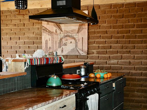 Kitchen with granite counter top and range hood, stove and oven