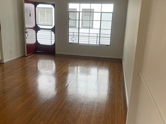 Living room, looking at front door and big window