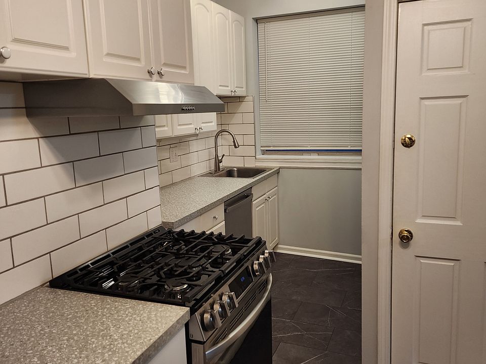 One side of the Kitchen with updated modern stainless steel appliances including stove and dishwasher.